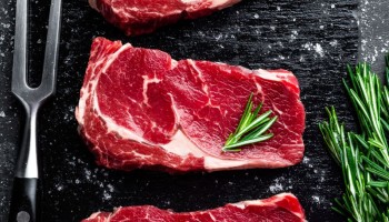 Raw meat, beef steak on black background, top view