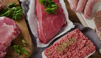 Different types of fresh raw meat on dark wooden background. Banner. Panorama